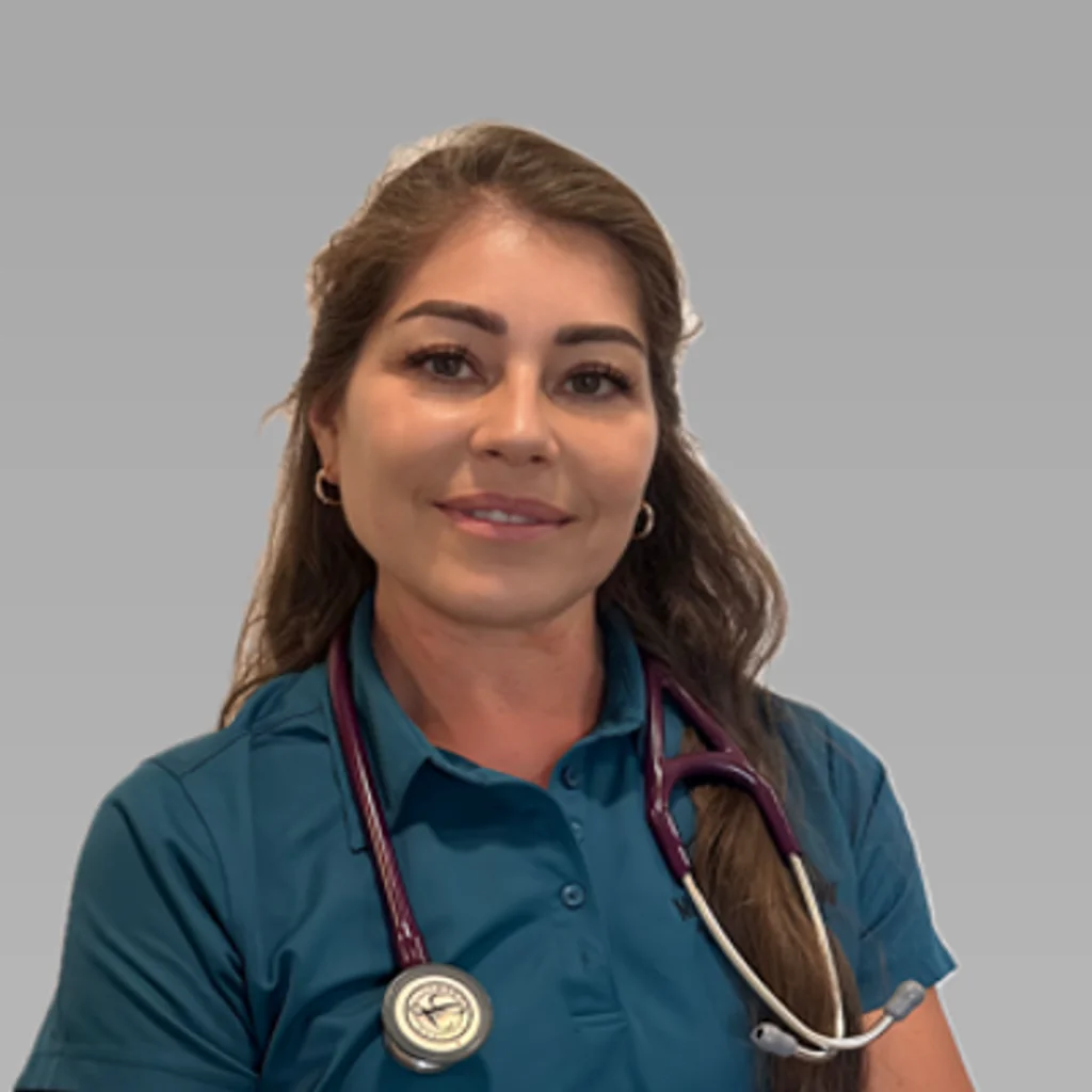 Dr. Violeta Gordillo, integrative veterinarian at Mountain View Animal Hospital, smiling at the camera against a plain grey background.