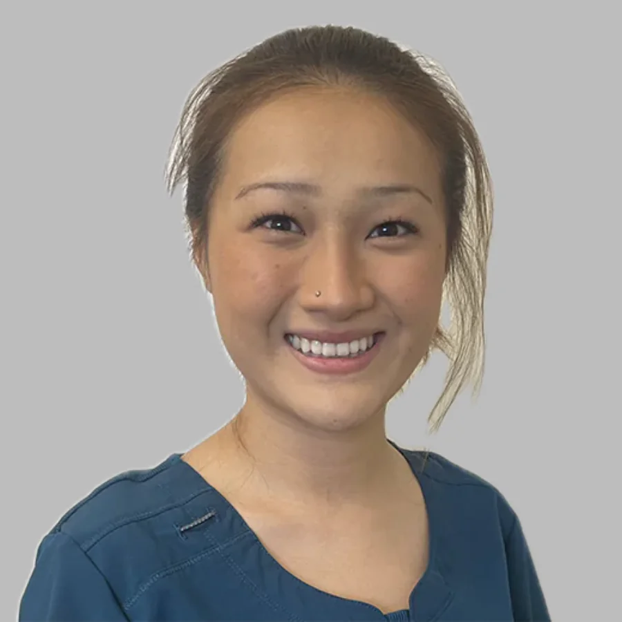 Elizabeth White, Mountain View Animal Hospital team member, smiling in teal scrubs against a gray background.